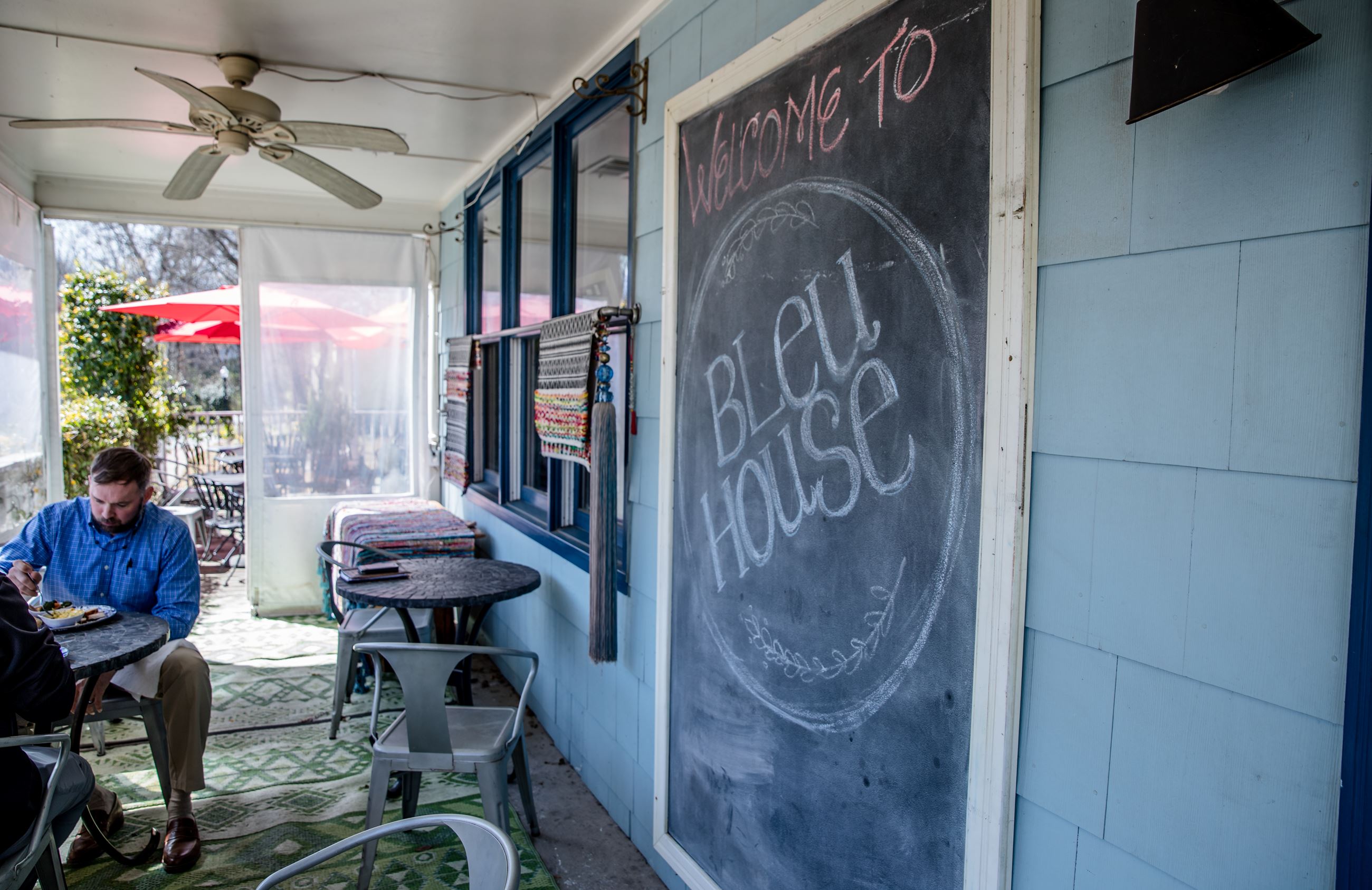porch of restaurant with chalkboard sign