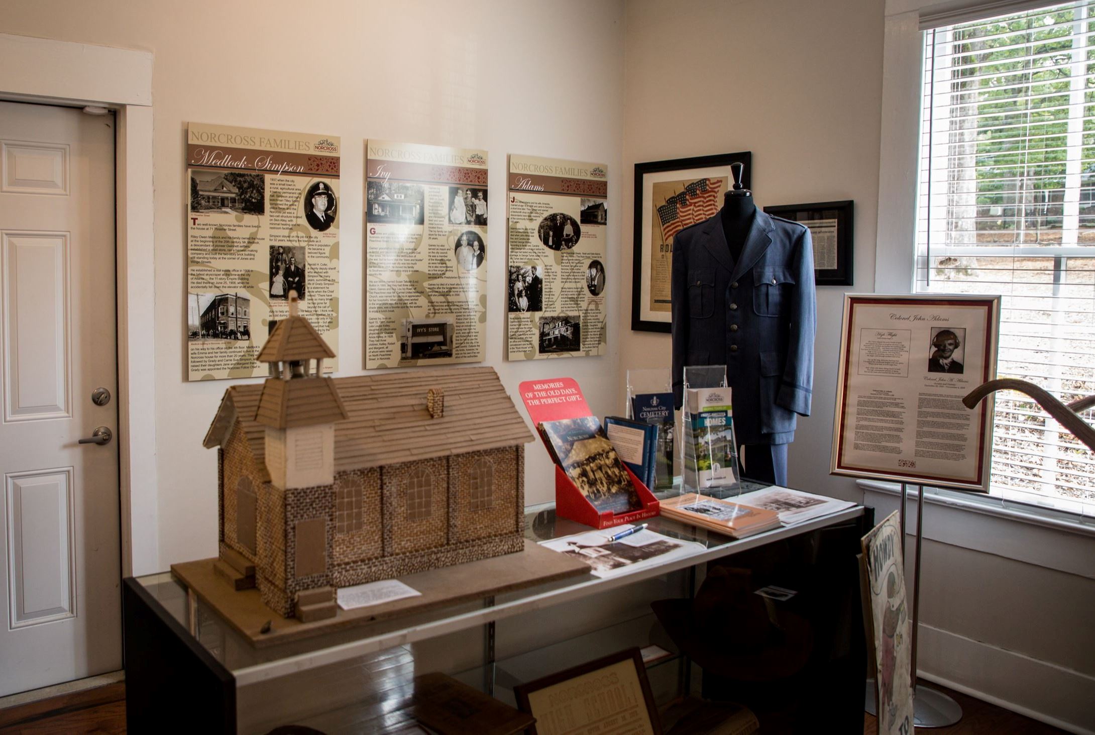 museum exhibit with model house and artifacts